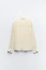 BLouse with embroidery, pleats, and shiny details